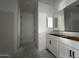 Bathroom featuring a double vanity, framed mirror, and modern fixtures at 4345 E Brook Lynn Pl, San Tan Valley, AZ 85143