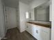 Clean bathroom with white cabinets and large mirror at 4345 E Brook Lynn Pl, San Tan Valley, AZ 85143
