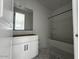 Modern bathroom with white vanity, framed mirror, and a tiled shower-tub combination at 4345 E Brook Lynn Pl, San Tan Valley, AZ 85143