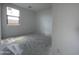 A minimalist bedroom with white walls, a window, and unfinished concrete flooring at 4345 E Brook Lynn Pl, San Tan Valley, AZ 85143