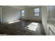 Spacious bedroom with wood look tile floors and natural light from two windows at 4345 E Brook Lynn Pl, San Tan Valley, AZ 85143