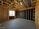 Framed walls and wood beam ceiling feature in the unfinished room with one window at 4345 E Brook Lynn Pl, San Tan Valley, AZ 85143