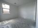 A bright, unfinished bedroom with white walls and concrete flooring at 4345 E Brook Lynn Pl, San Tan Valley, AZ 85143