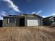 New construction single-Gathering home featuring a gray stucco exterior and two-car garage at 4345 E Brook Lynn Pl, San Tan Valley, AZ 85143