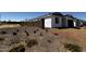 Home under construction, showcasing block wall and native landscaping with flowering plants at 4345 E Brook Lynn Pl, San Tan Valley, AZ 85143