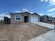 Single-story home featuring a gray stucco exterior, a two-car garage, and a concrete driveway at 4345 E Brook Lynn Pl, San Tan Valley, AZ 85143