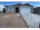 A charming single-story home featuring a gray stucco exterior, a two-car garage, and a concrete driveway at 4345 E Brook Lynn Pl, San Tan Valley, AZ 85143