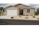 Attractive one-story home featuring desert landscaping, a two-car garage, and a covered entry at 4345 E Brook Lynn Pl, San Tan Valley, AZ 85143