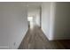 An expansive hallway with elegant tile flooring, leading to a view of a bright and open living space at 4345 E Brook Lynn Pl, San Tan Valley, AZ 85143