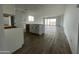 Open kitchen with white cabinets and wood look tile floors, perfect for entertaining at 4345 E Brook Lynn Pl, San Tan Valley, AZ 85143