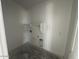 A blank laundry room canvas featuring white walls and utility connections at 4345 E Brook Lynn Pl, San Tan Valley, AZ 85143