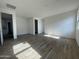 Open living room featuring wood look tile floors and ample natural light at 4345 E Brook Lynn Pl, San Tan Valley, AZ 85143