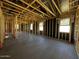 The interior of an unfinished home is framed with exposed wood and black paper at 4345 E Brook Lynn Pl, San Tan Valley, AZ 85143
