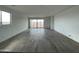 Spacious living room featuring wood look tile floors and sliding glass doors to the backyard at 4345 E Brook Lynn Pl, San Tan Valley, AZ 85143