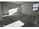 Bright living room with two windows, neutral walls, and a spacious open floor plan at 4345 E Brook Lynn Pl, San Tan Valley, AZ 85143