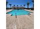 Community swimming pool with lounge chairs, palm trees, and sun shades at 4345 E Brook Lynn Pl, San Tan Valley, AZ 85143