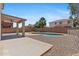 A large backyard with desert landscaping and a covered patio perfect for outdoor gatherings at 43507 W Cydnee Dr, Maricopa, AZ 85138