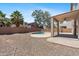 An ample backyard with desert landscaping, refreshing pool, and a covered patio at 43507 W Cydnee Dr, Maricopa, AZ 85138