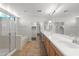 Bright bathroom with double vanity, walk-in shower, and a soaking tub at 43507 W Cydnee Dr, Maricopa, AZ 85138
