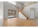 Bright living room with tile floors, staircase, and sliding doors to the backyard at 43507 W Cydnee Dr, Maricopa, AZ 85138