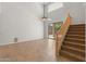 Bright living room with tile floors, staircase, and sliding doors to the backyard at 43507 W Cydnee Dr, Maricopa, AZ 85138