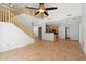 Spacious living room with high ceilings, stairs, and an open view to the kitchen at 43507 W Cydnee Dr, Maricopa, AZ 85138
