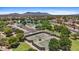 Aerial shot of the community tennis courts, lush landscaping, and parking area at 43507 W Cydnee Dr, Maricopa, AZ 85138