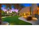 Expansive backyard with manicured lawn, patio, and fire pit seating area at 4450 E Camelback Rd # 4, Phoenix, AZ 85018