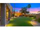 Beautiful backyard featuring green grass, stone patio, and manicured landscaping at 4450 E Camelback Rd # 4, Phoenix, AZ 85018