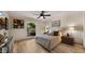 Cozy bedroom featuring wood-look floors, a ceiling fan, and comfortable decor at 4450 E Camelback Rd # 4, Phoenix, AZ 85018