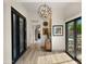 Bright foyer featuring wood-look tile flooring, modern lighting, and stylish decor at 4450 E Camelback Rd # 4, Phoenix, AZ 85018