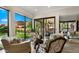 Comfortable living area features glass doors, neutral toned furniture and decorative light fixture at 4450 E Camelback Rd # 4, Phoenix, AZ 85018