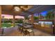 Outdoor dining area with built-in grill and mountain views at dusk at 4450 E Camelback Rd # 4, Phoenix, AZ 85018