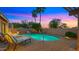 Backyard pool area with brick pavers, waterfall feature, and lounge chairs at 4450 E Camelback Rd # 4, Phoenix, AZ 85018