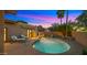 Inviting pool area with a waterfall feature, lush landscaping, and lounge chairs at 4450 E Camelback Rd # 4, Phoenix, AZ 85018