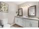 Bright bathroom with double sinks, granite countertops, framed mirrors, and modern lighting fixtures at 508 S Ernie Pl, Tempe, AZ 85281