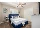 Cozy bedroom featuring a blue bedframe, window shutters, ceiling fan, and carpeted floors at 508 S Ernie Pl, Tempe, AZ 85281