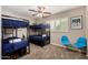 Bedroom with two bunk beds, blue chairs, a ceiling fan and a large window at 508 S Ernie Pl, Tempe, AZ 85281