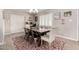 Elegant dining room with stylish lighting, a large table, and plantation shutters at 508 S Ernie Pl, Tempe, AZ 85281