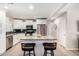 Updated kitchen with island, stainless steel appliances, white cabinets, and granite counters at 508 S Ernie Pl, Tempe, AZ 85281