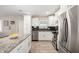 Bright kitchen with white cabinets, stainless steel appliances, and granite countertops at 508 S Ernie Pl, Tempe, AZ 85281