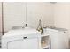 Functional laundry room with a white brick wall, white shelving, and modern washing machines at 508 S Ernie Pl, Tempe, AZ 85281