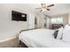 Comfortable main bedroom featuring a ceiling fan, TV, and an ensuite bathroom with a sliding barn door at 508 S Ernie Pl, Tempe, AZ 85281