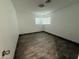Bright bedroom with wood-look floors, a ceiling light, and a window with blinds at 5338 W Wolf St, Phoenix, AZ 85031