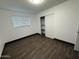 Bedroom with hardwood floors, closet and window with blinds at 5338 W Wolf St, Phoenix, AZ 85031