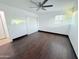 Bedroom featuring wood-look floors, a ceiling fan, closet, and a window with blinds at 5338 W Wolf St, Phoenix, AZ 85031