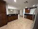An open-concept kitchen features lots of cabinet space, stainless appliances, and tiled floors at 5338 W Wolf St, Phoenix, AZ 85031