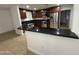 This kitchen is beautifully appointed with dark cabinets, stainless steel appliances, and granite countertops at 5338 W Wolf St, Phoenix, AZ 85031