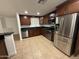 A kitchen features dark cabinets, stainless steel appliances, and granite countertops at 5338 W Wolf St, Phoenix, AZ 85031