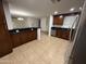 An open-concept kitchen provides lots of cabinet space, stainless appliances, and tiled floors at 5338 W Wolf St, Phoenix, AZ 85031